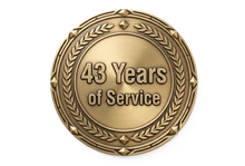 Gold circular service award medal reading “43 Years of Service” with laurel wreath border