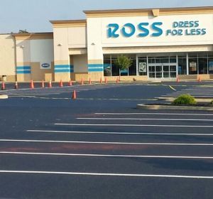 Ross Dress for Less storefront with empty parking lot and blue signage