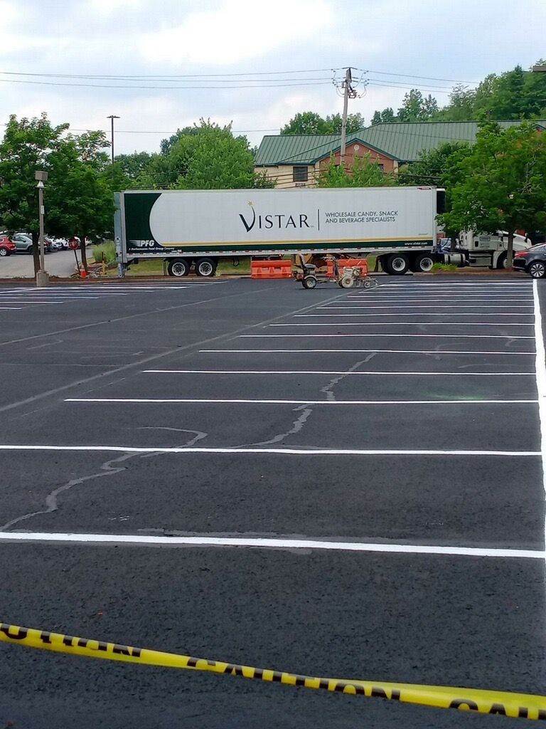 Parked white Vistar trailer in an empty lot, with yellow caution tape in the foreground.