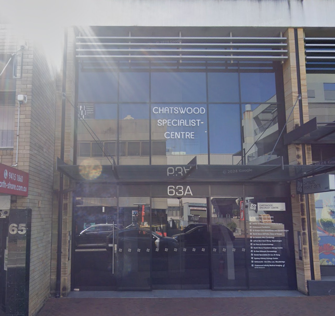Entrance to Chatswood Specialist Centre at 63A with glass doors, brick facade, and reflective windows.