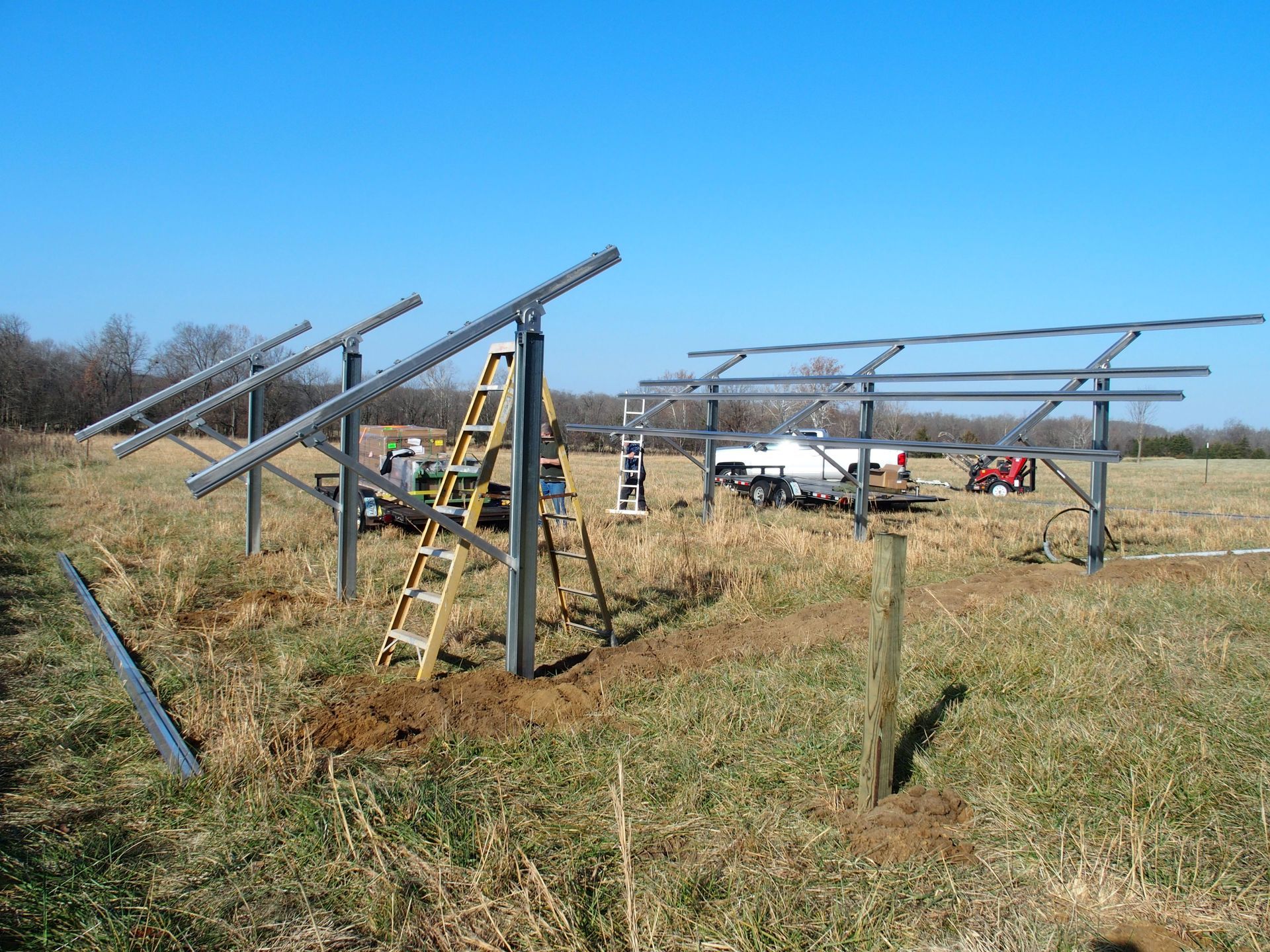 A group of solar panels are being built in a field
