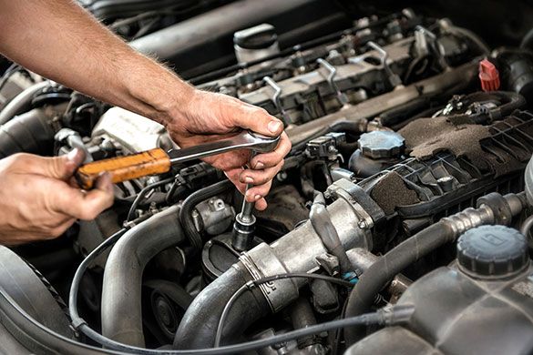 A person working on a car engine — Moravia, NY — Auto Body Repair A person working on a car engine — Moravia, NY — Auto Body Repair
