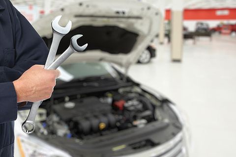 A person holding wrench — Moravia, NY — Auto Body Repair A person holding wrench — Moravia, NY — Auto Body Repair