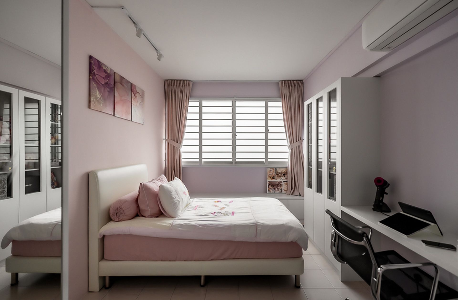 A bedroom with a large bed and a desk.
