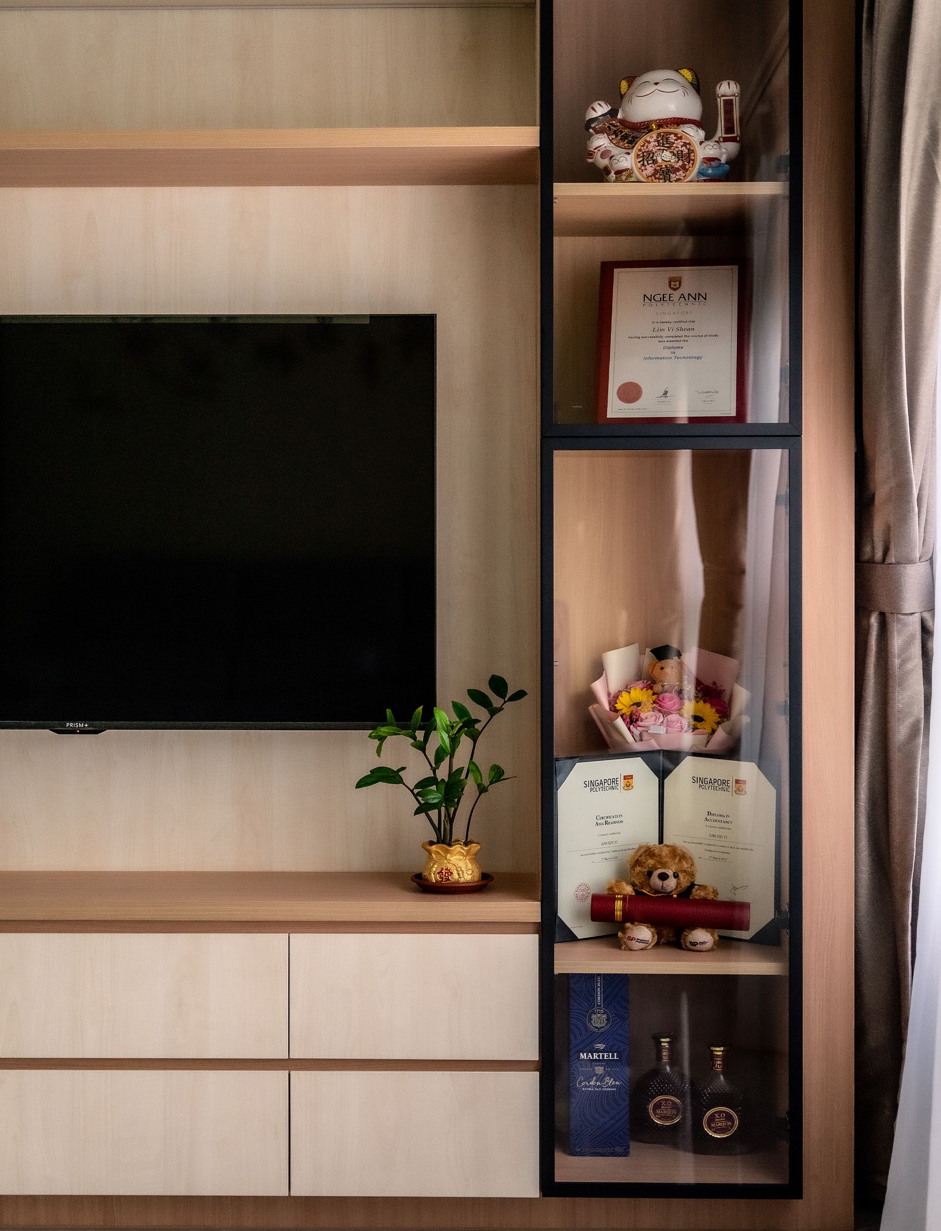 A living room with a flat screen tv and shelves