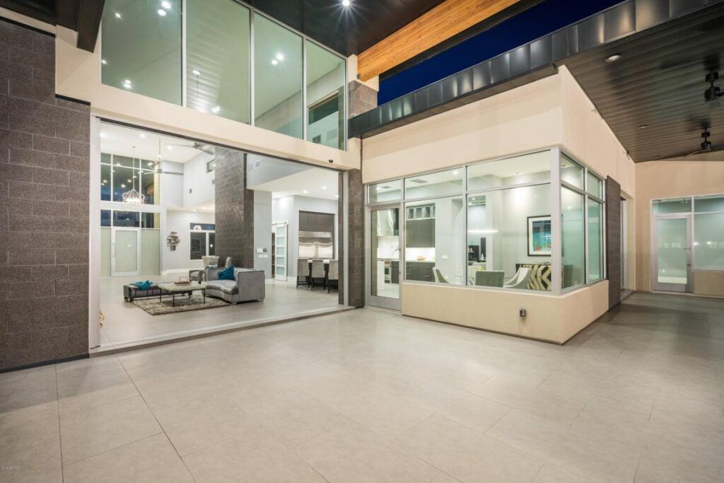A large house with a lot of windows and a patio.