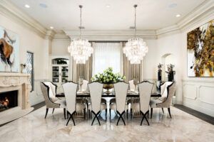 A large dining room with a table and chairs and a fireplace.