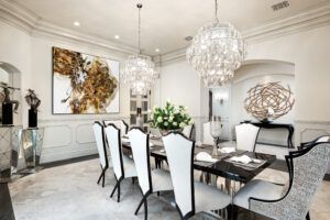 A dining room with a table and chairs and a chandelier