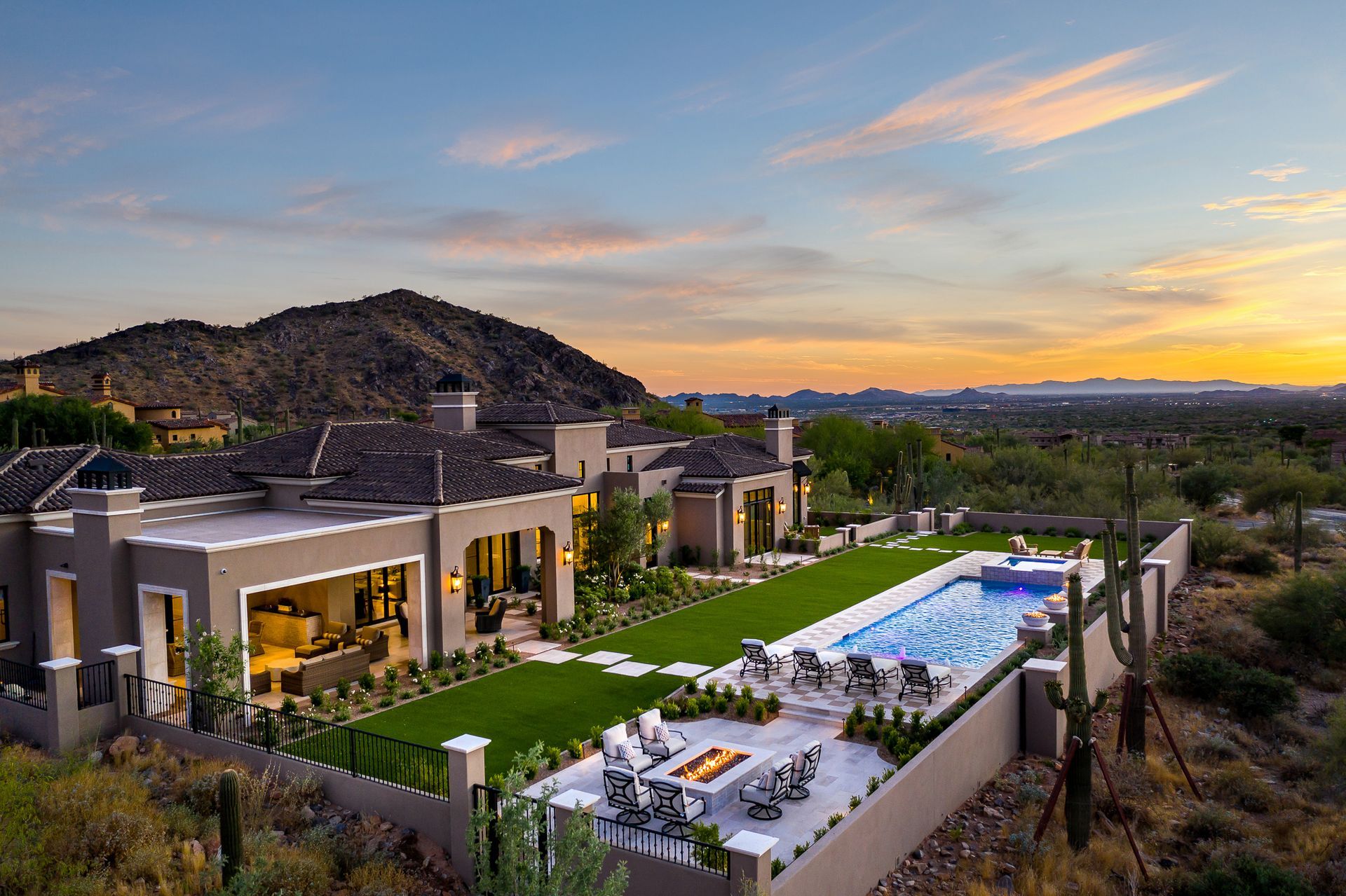 A large house with a large swimming pool in front of it.