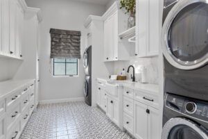 A laundry room with a washer and dryer stacked on top of each other.