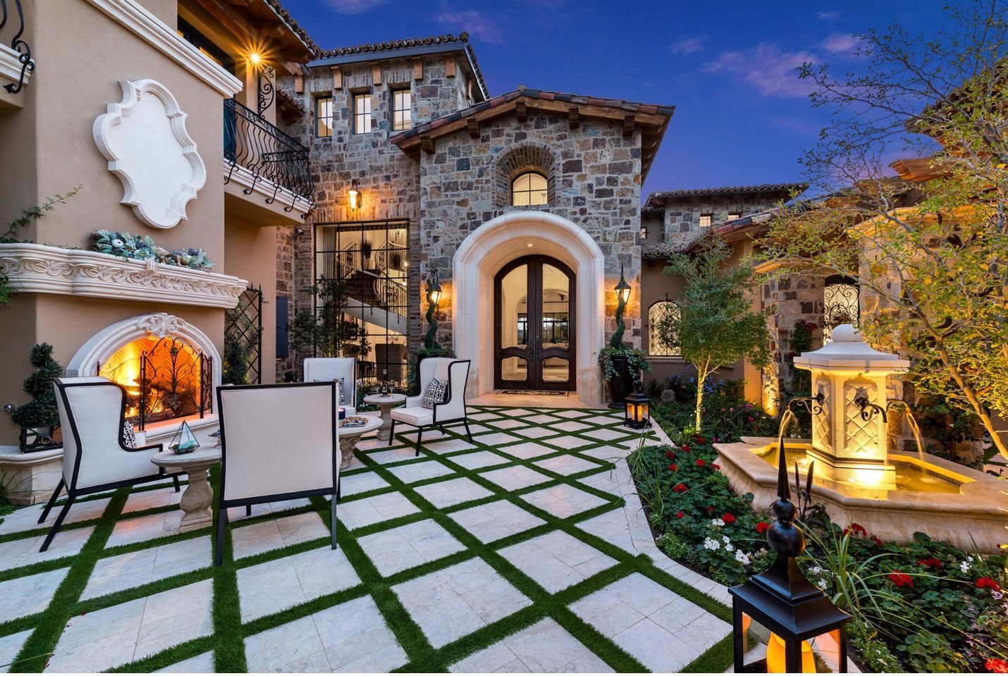 A large house with a fireplace in the backyard