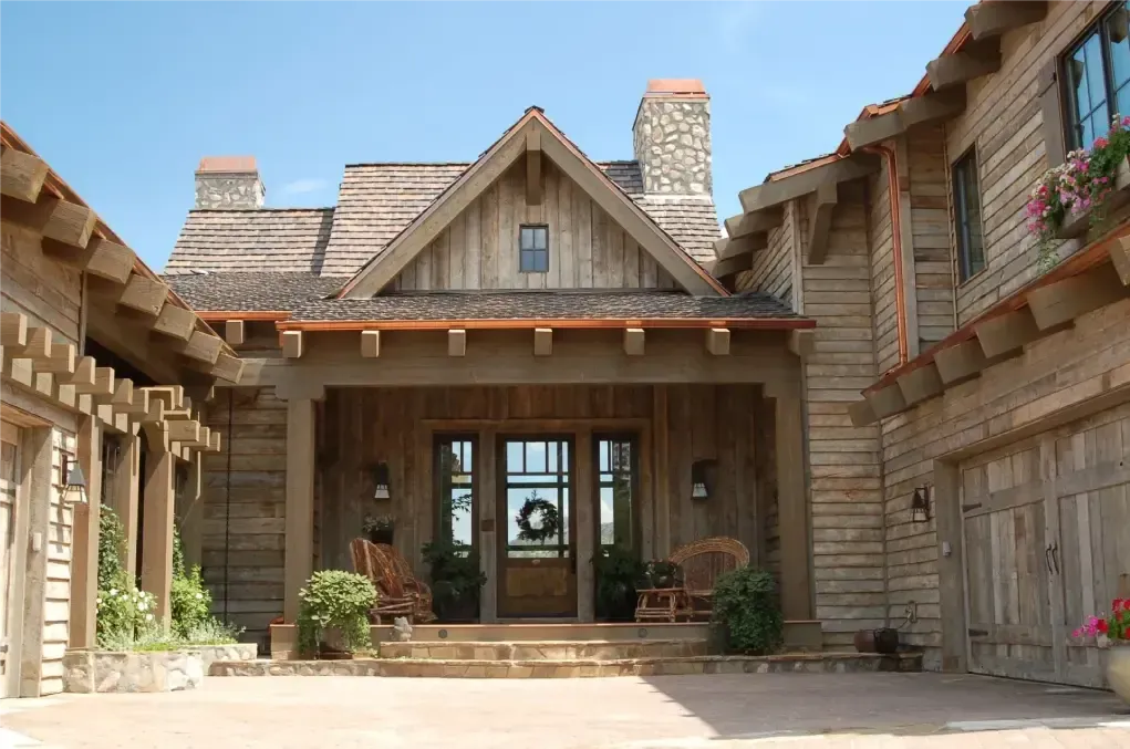 Rustic adaptive reuse home exterior with reclaimed wood and stone details