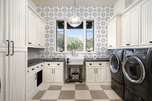 A laundry room with a washer and dryer and a checkered floor.