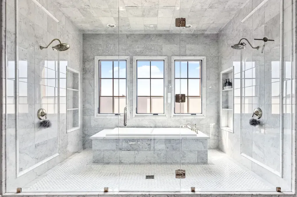 enclosed double shower and tub in white and grey tile