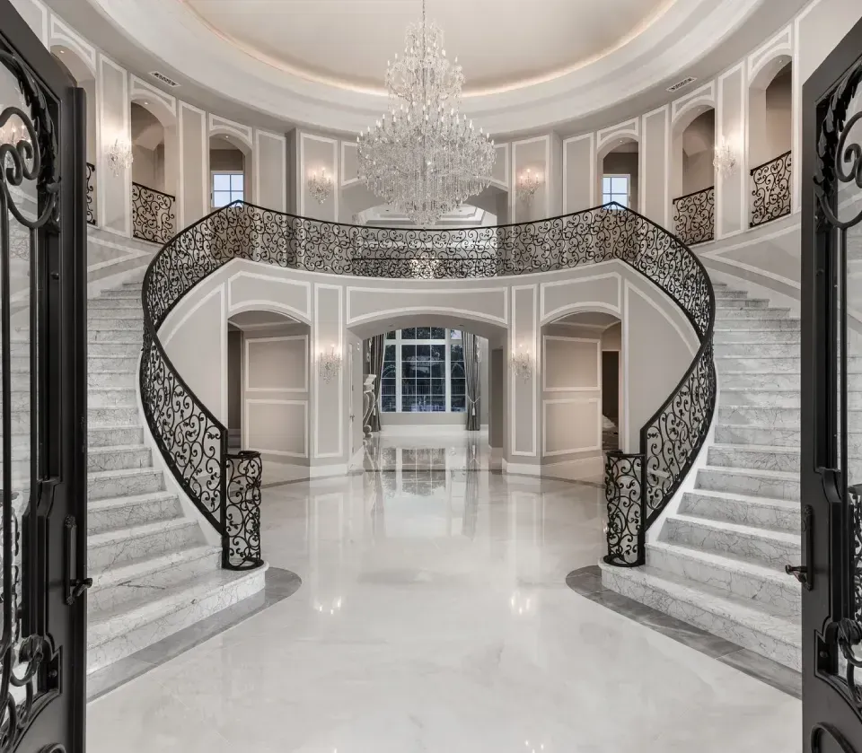 Luxury entryway with grand double staircase and chandelier