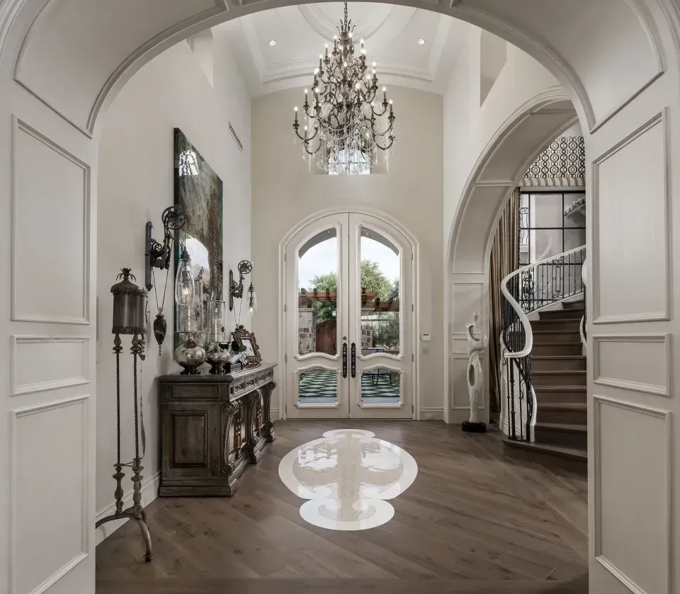 Luxury foyer with elegant chandelier and custom staircase