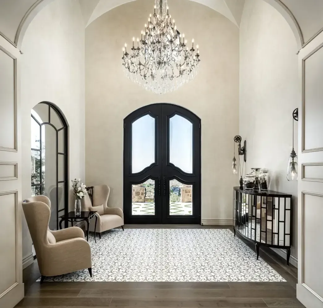A large hallway with a chandelier hanging from the ceiling.