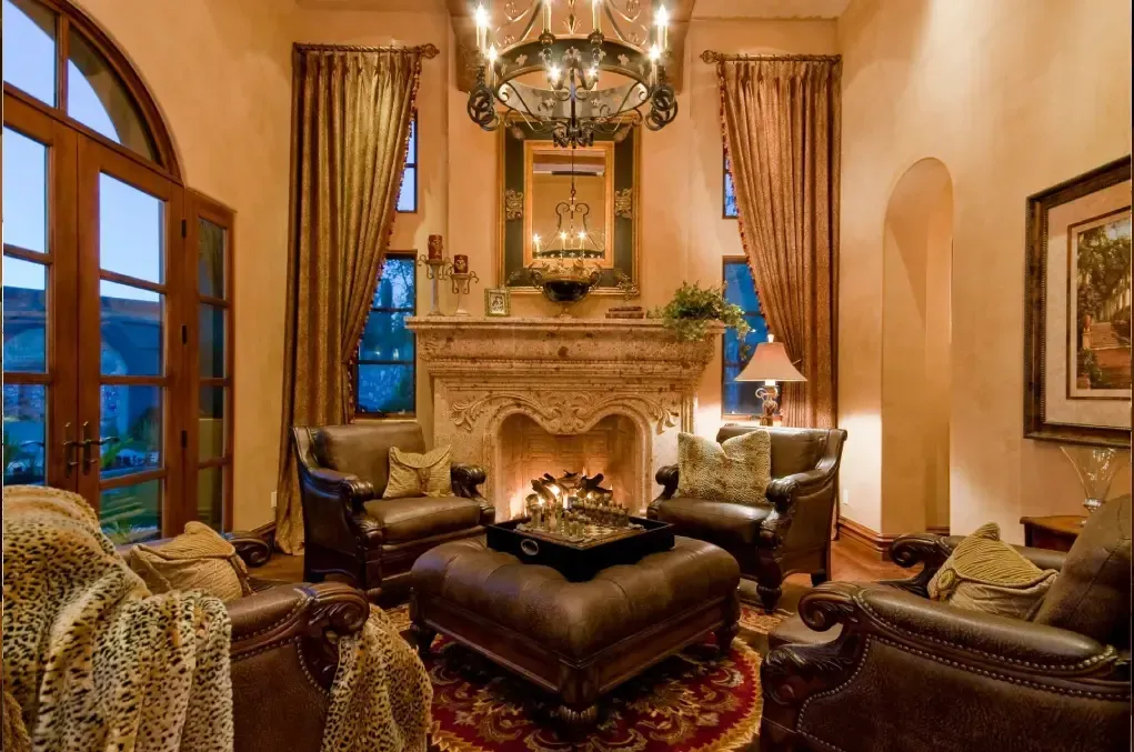 Luxury Mediterranean living room with ornate fireplace and chandelier