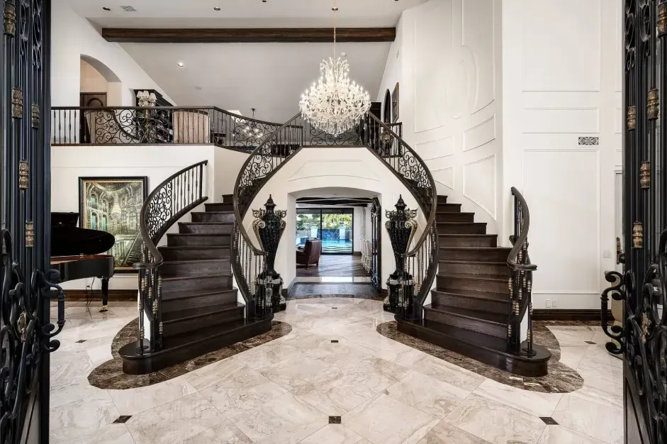 Grand staircase in Paradise Villa with elegant railing and chandelier