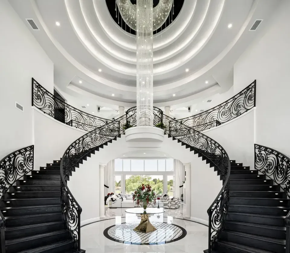 Luxury foyer with statement ceiling and grand staircase