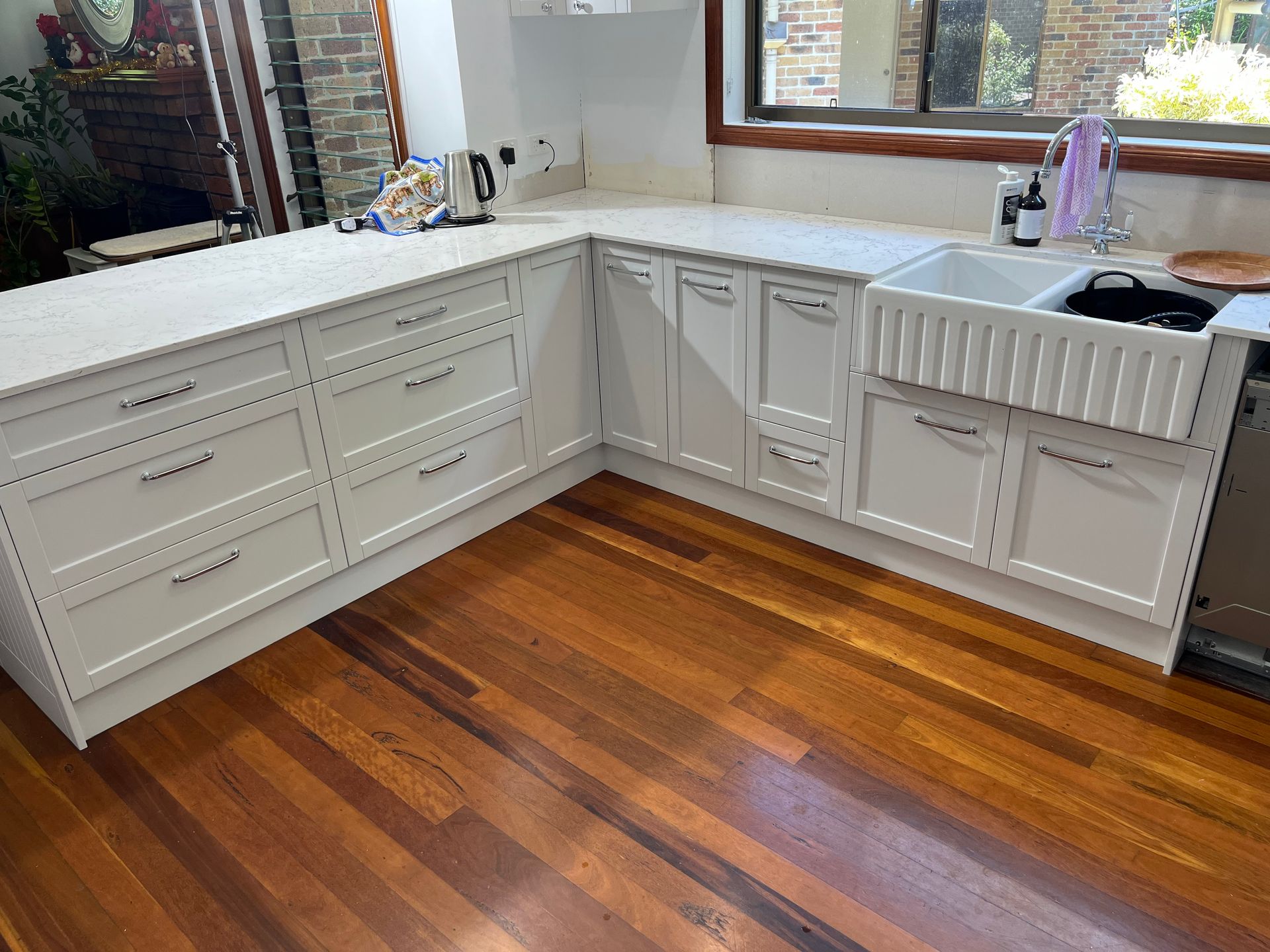 White Countertop and Cabinets Complementing Modern Kitchen Design — Against the Grain Cabinetry in Rosemount, QLD