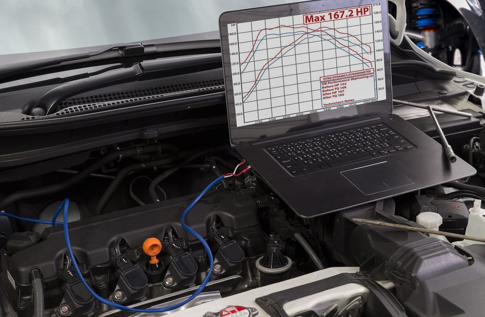 A Laptop is Sitting on Top of a Car Engine — Dynamic Performance Systems in Hobart, TAS