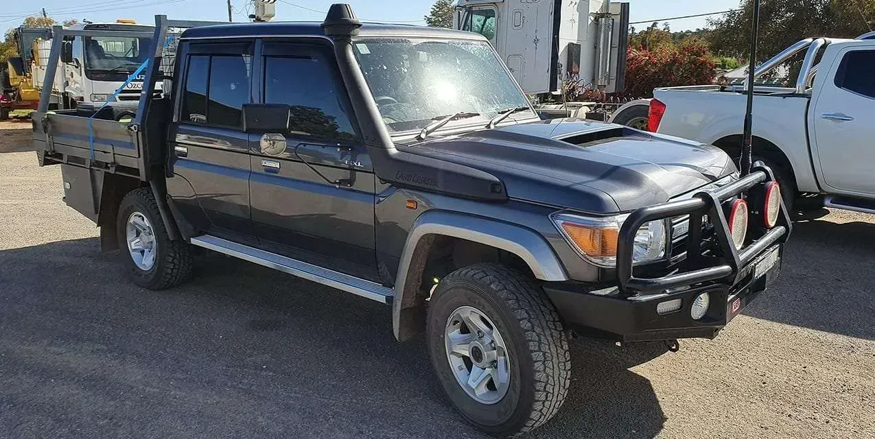 A Black Truck With a Snorkel on the Hood is Parked in a Gravel Lot — Dynamic Performance Systems In Kelso, NSW