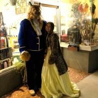 Costumed couple posing in a shop, Beauty and the Beast.
