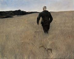 A man is walking through a field of tall grass.