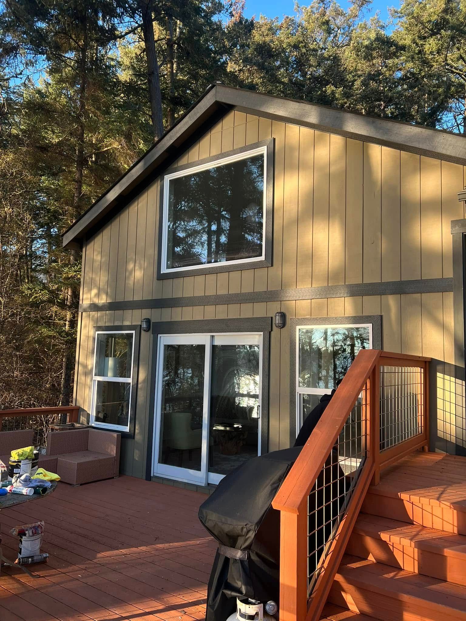 a residential exterior of a yellow house with a nice, large wooden deck