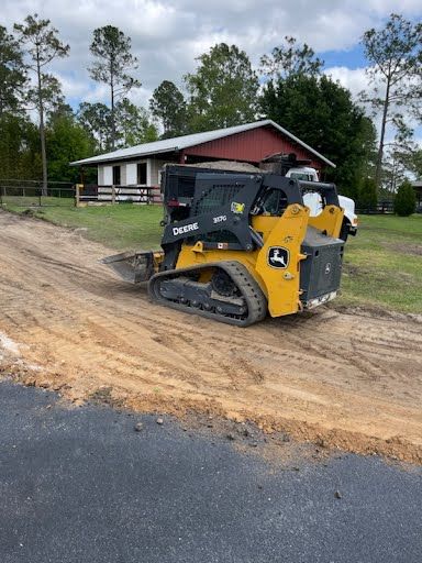 bulldozer pushing dirt while grading land with digger in background