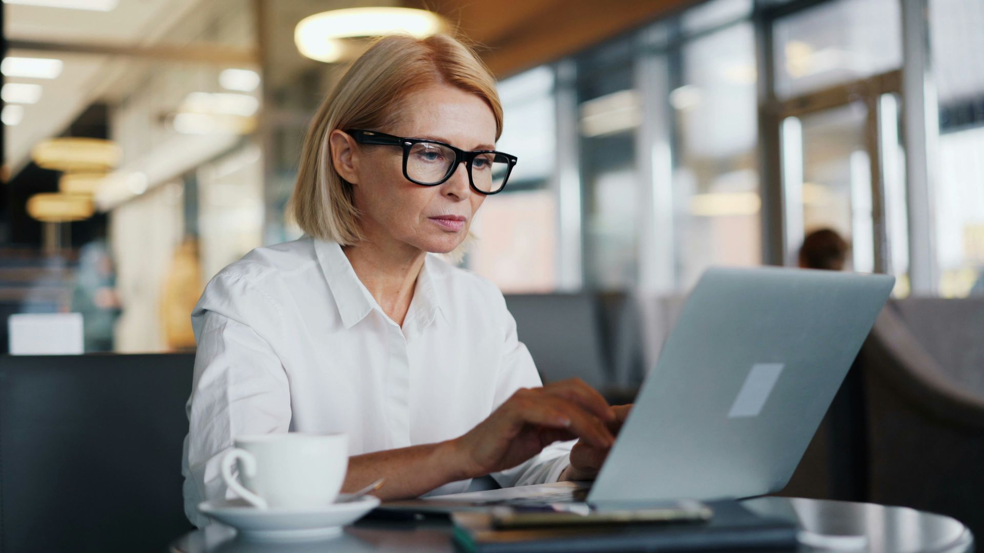 Woman typing positive QuickBooks review for Long Island Class