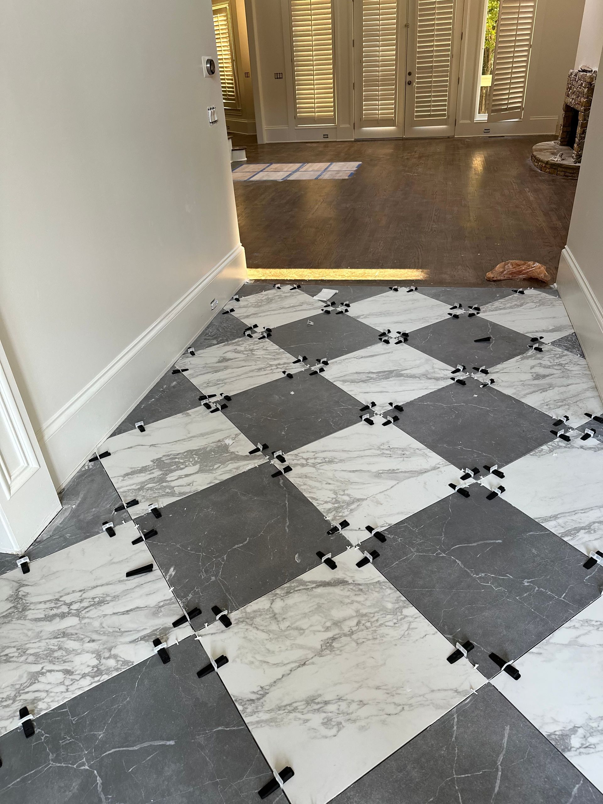 A black and white checkered tile floor in a hallway.