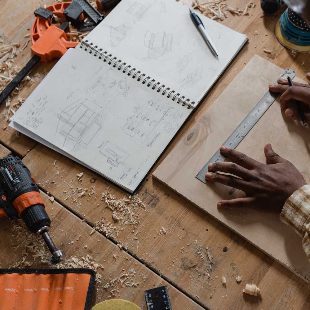 A person is using a ruler to measure a piece of wood.