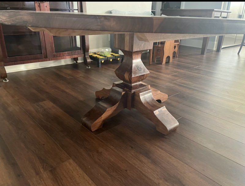 A wooden table is sitting on a wooden floor in a room.