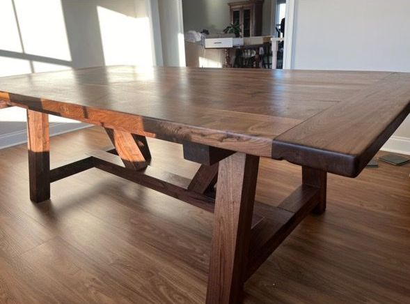 A wooden table is sitting on a wooden floor in a living room.