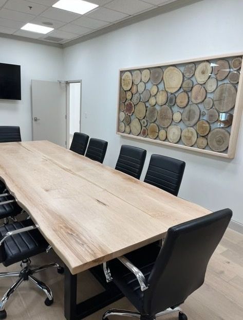A conference room with a long wooden table and chairs