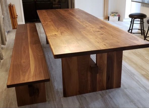 A long wooden table with a bench underneath it