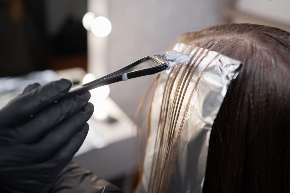 Close-up of a strand of female hair on a special sheet of foil