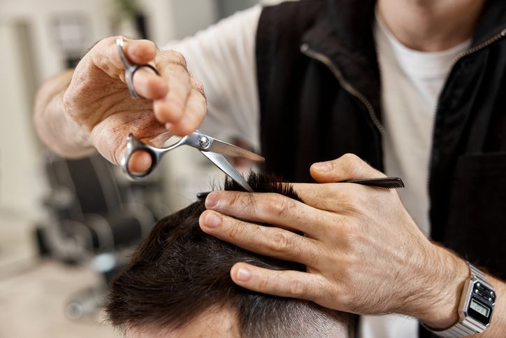 Professional hairdresser provides haircut at hair salon, Hamburg, NY