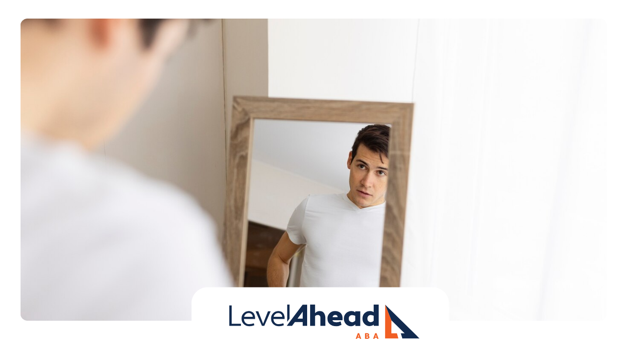 An autistic adult looking at himself in the mirror