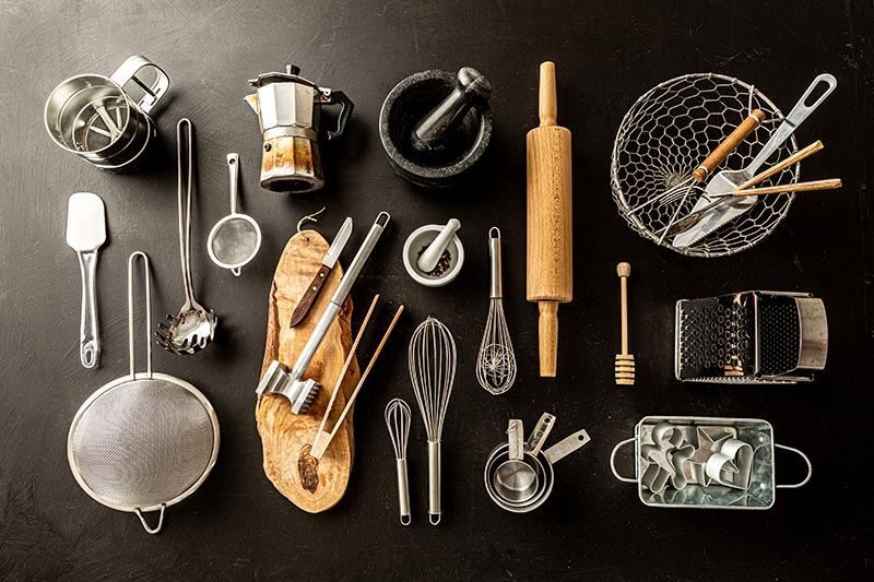 There are many different types of kitchen utensils on the table.