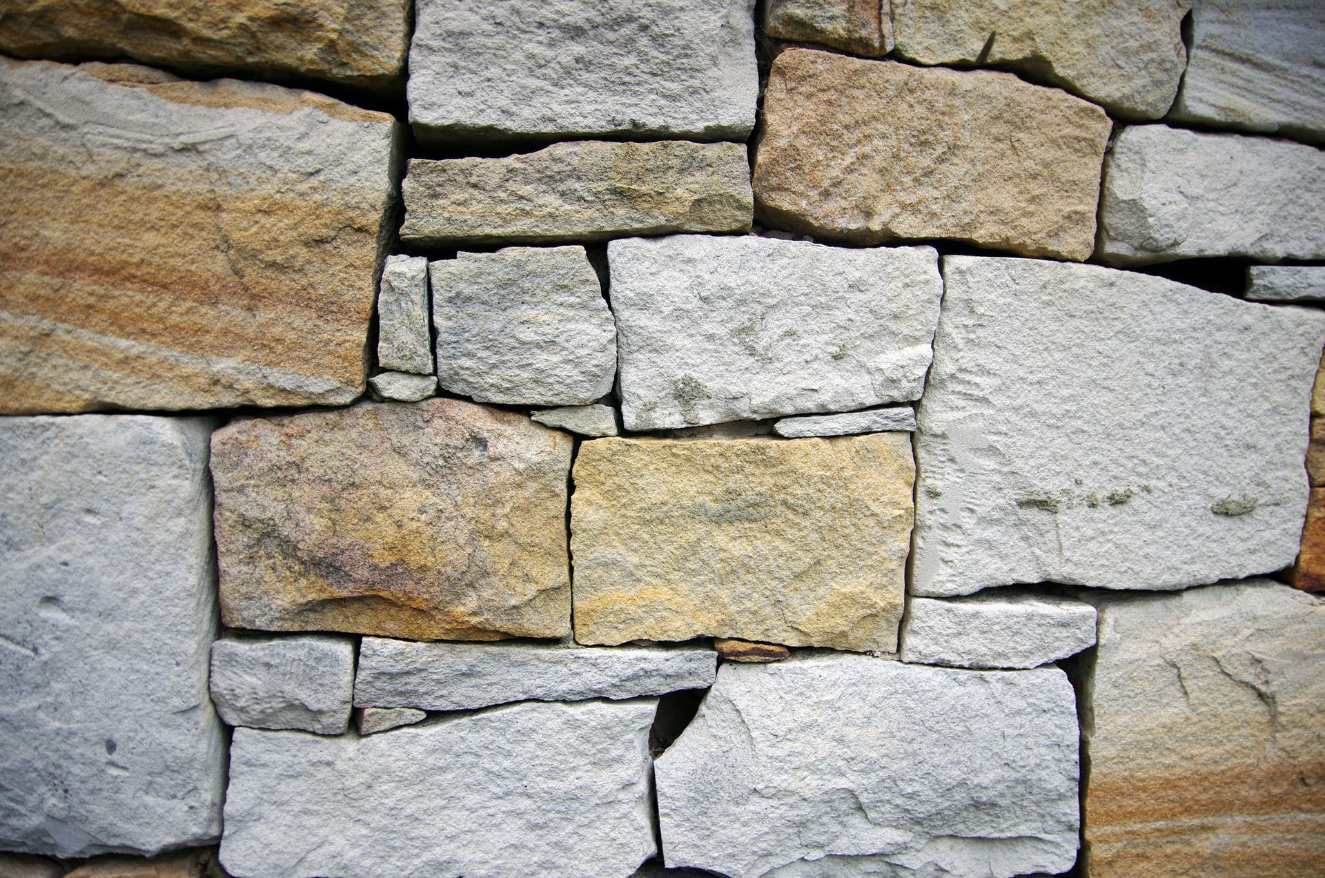 A close up of a stone wall made of different colored stones
