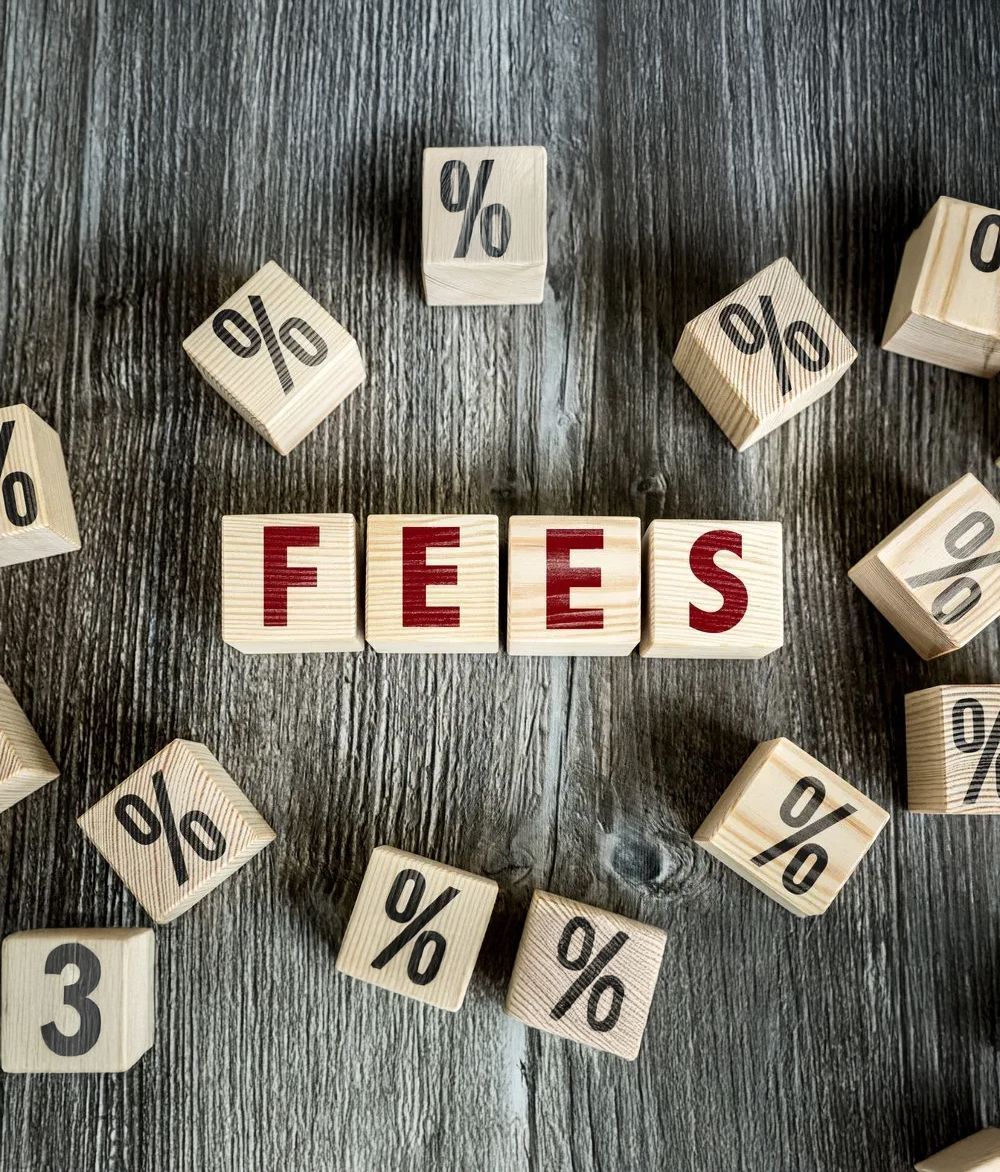 The Word Fees Is Written on Wooden Blocks on A Wooden Table — Health Hub Mackay in Mackay, QLD