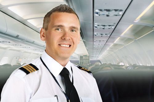 A Man in A White Shirt and Tie Is Standing in An Airplane — Health Hub Mackay in Mackay, QLD