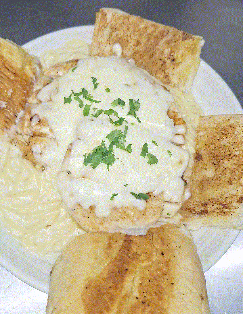 Plate of creamy dip topped with herbs, surrounded by toasted bread wedges