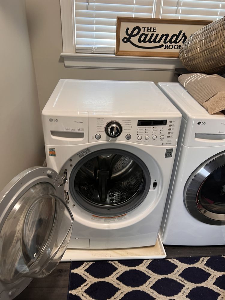 A washer and dryer are sitting next to each other in a laundry room.