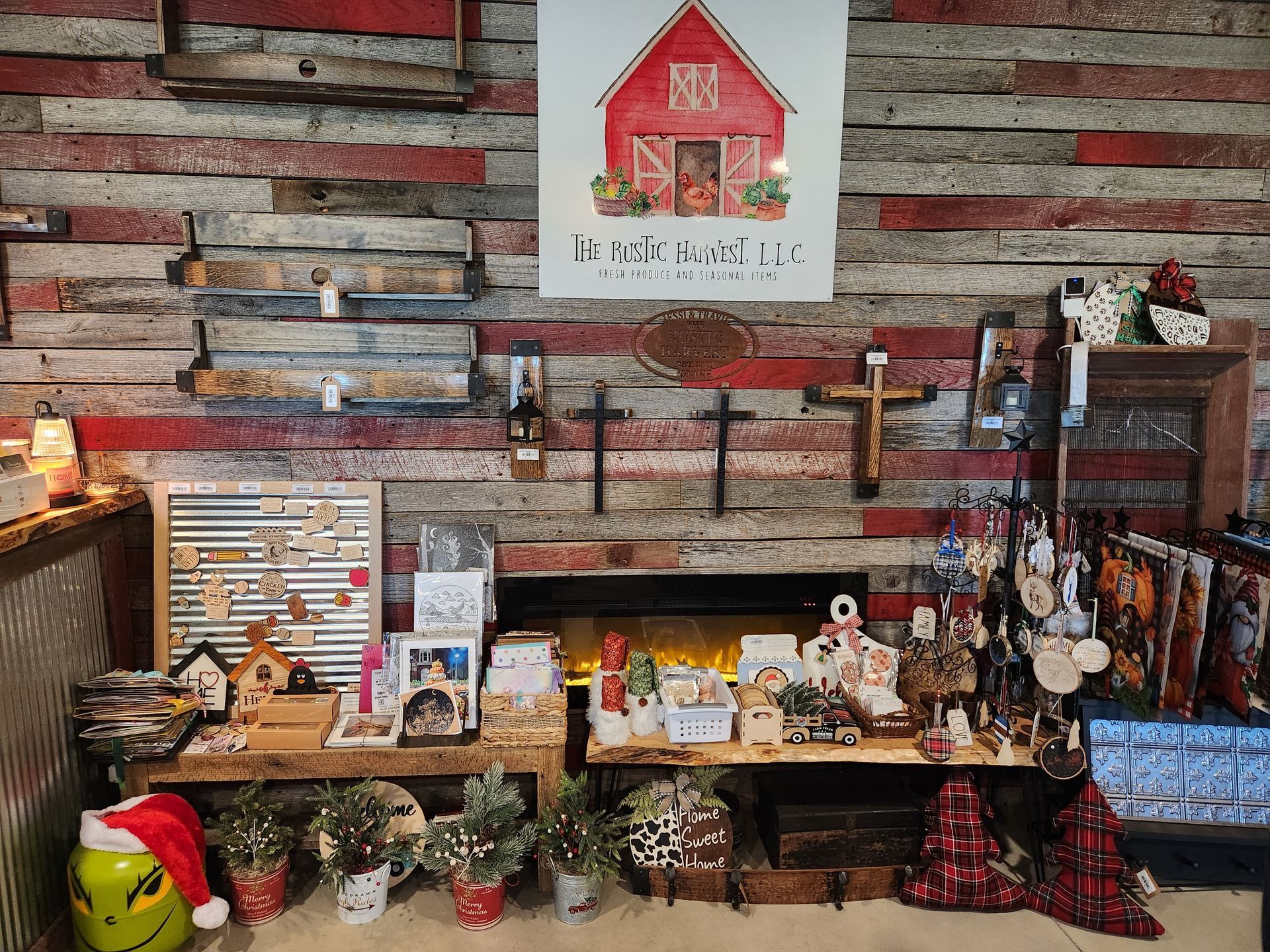 A room with a wooden wall and a fireplace filled with christmas decorations.