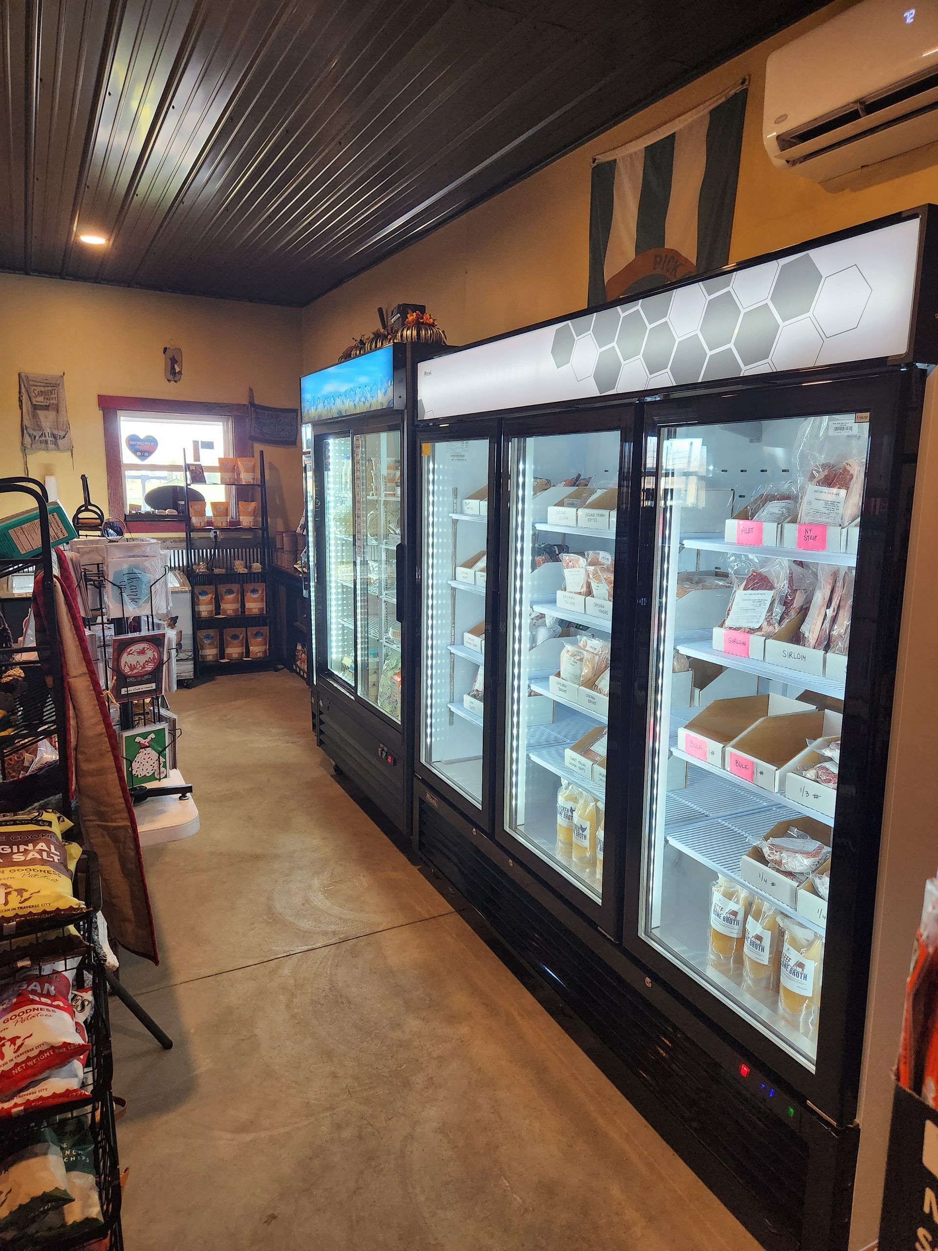 A grocery store with a lot of refrigerators and shelves