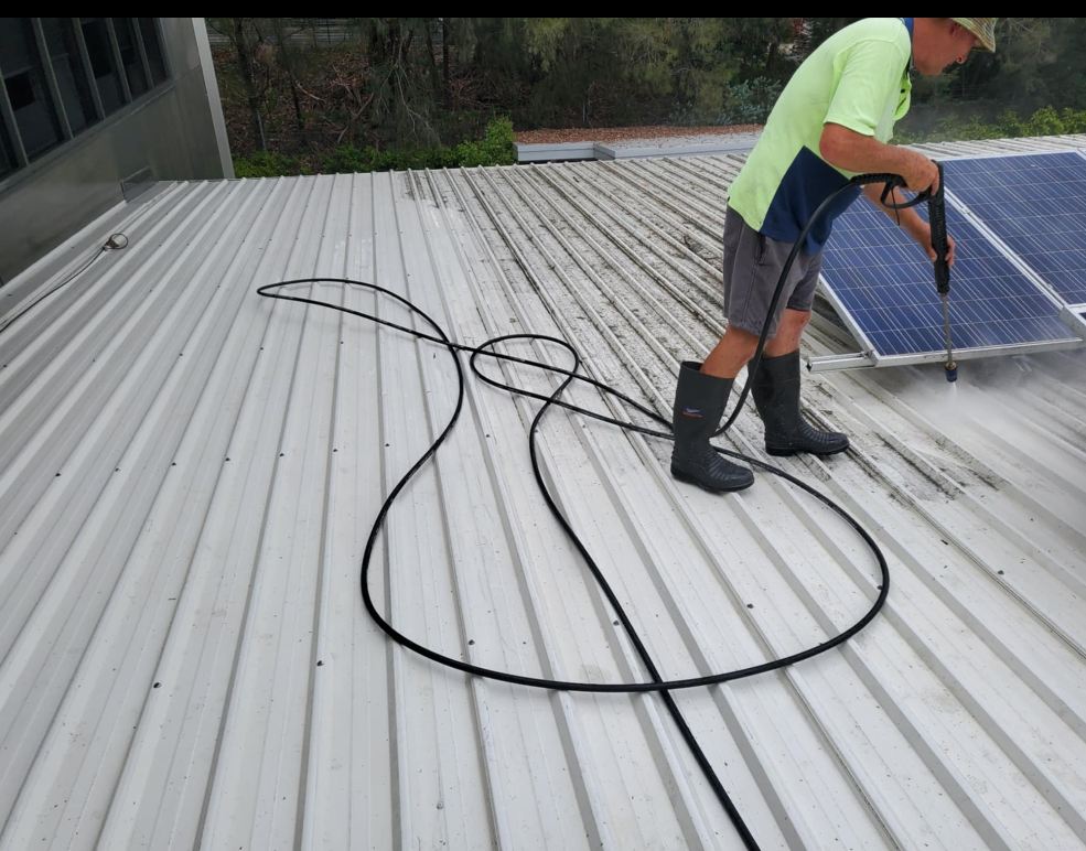 A Man Is Using a High Pressure Washer to Clean a roof — KJ's Elite Cleaning Services Newcastle in East Maitland, NSW